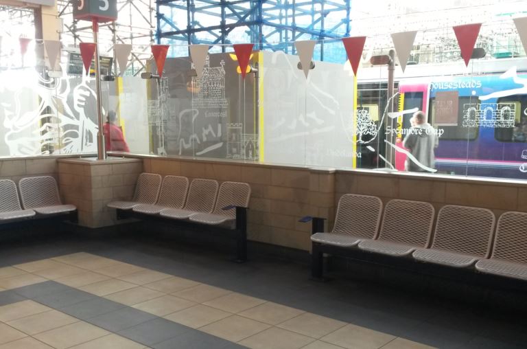Although many stations have seats those close to the platforms are often noisy and people are constantly walking past. At Carlisle station there are several enclosed seating areas with glass to minimise the noise but let in the light allowing people to relax. Missing are tables and power-points