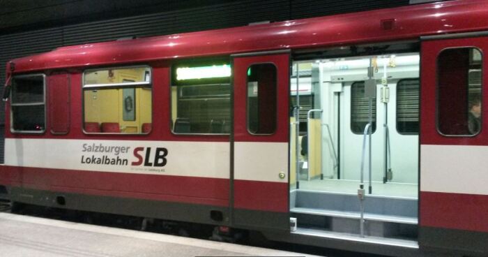 Photo of one of the older Lokalbahn trains waiting for passengers to board in the underground platform at Salzburg Hauptbahnhof station